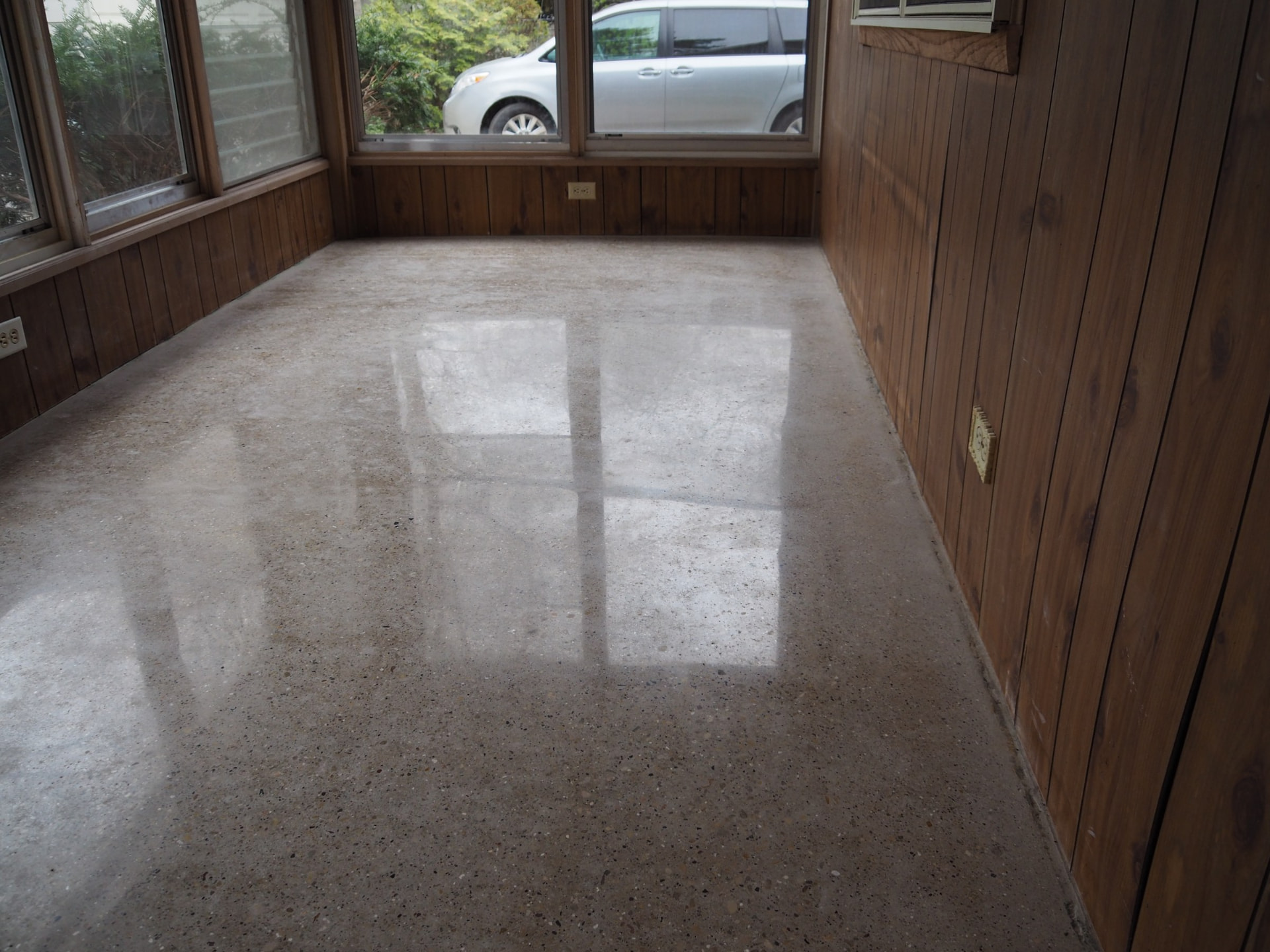 Close-up of the same porch concrete after polishing to a smooth finish