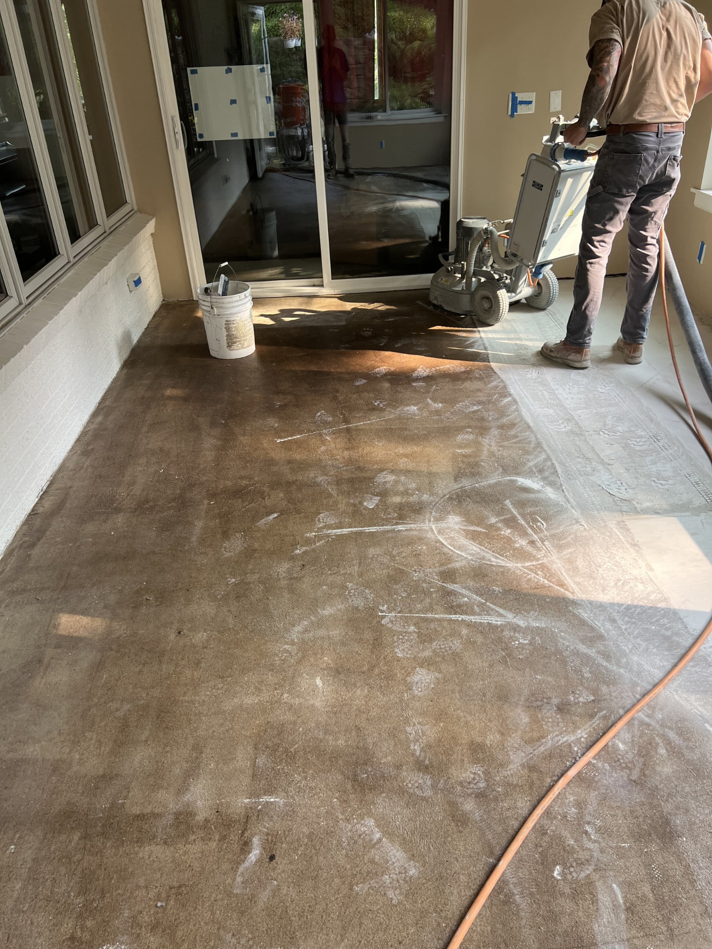 Concrete grinder working a slab during the grinding stage of polishing