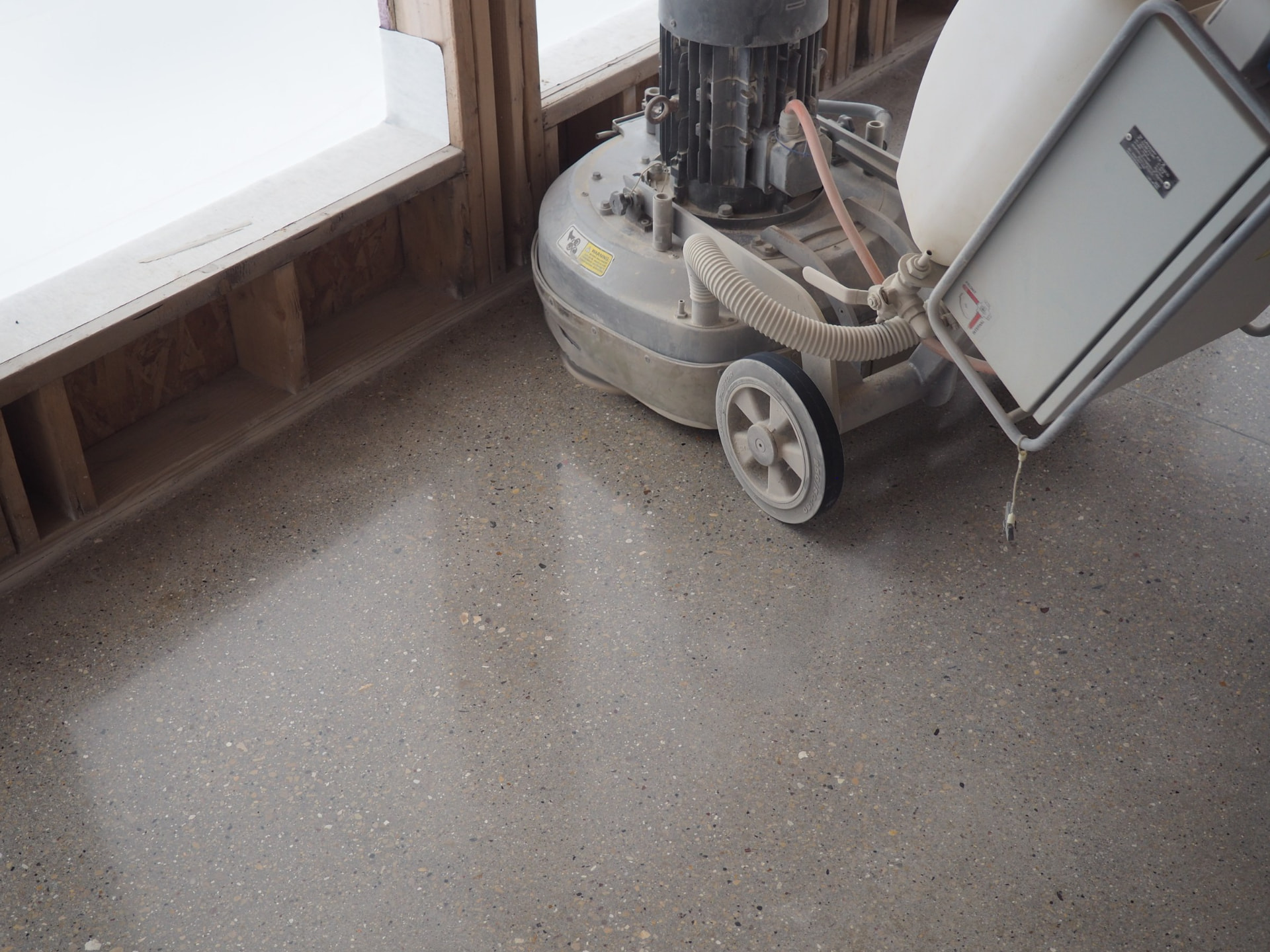 Overhead view of a grinder making a final pass on polished concrete